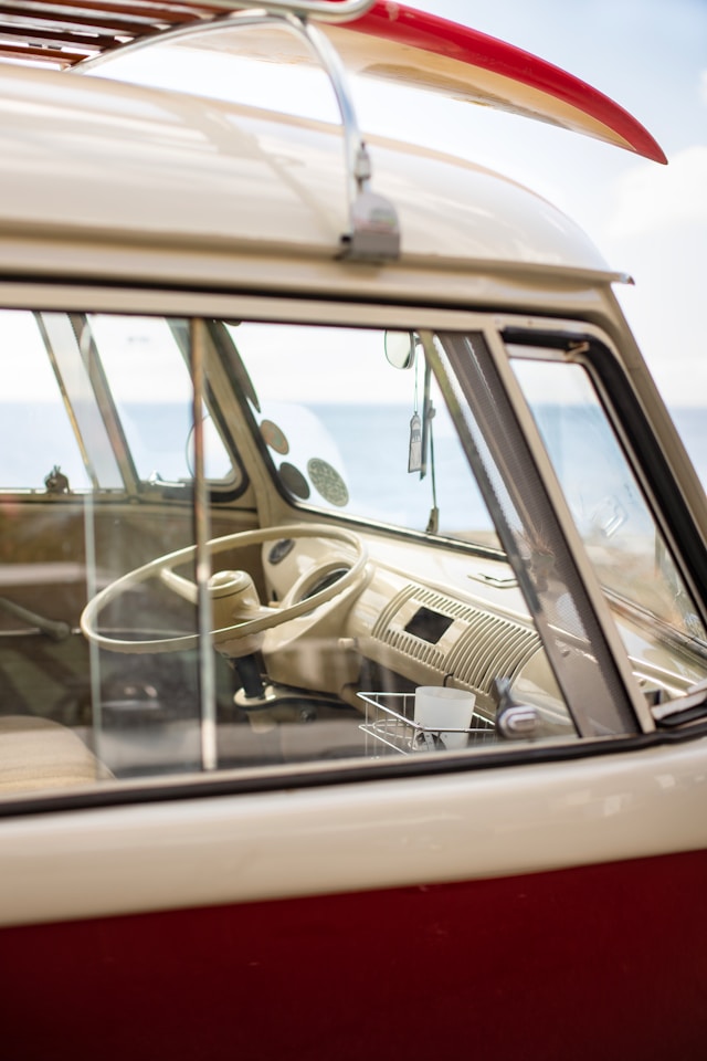 Habitacle de Volkswagen Combi de collection avec tableau de bord d'origine, volant caractéristique et aménagement intérieur typique des combis Volkswagen anciens.