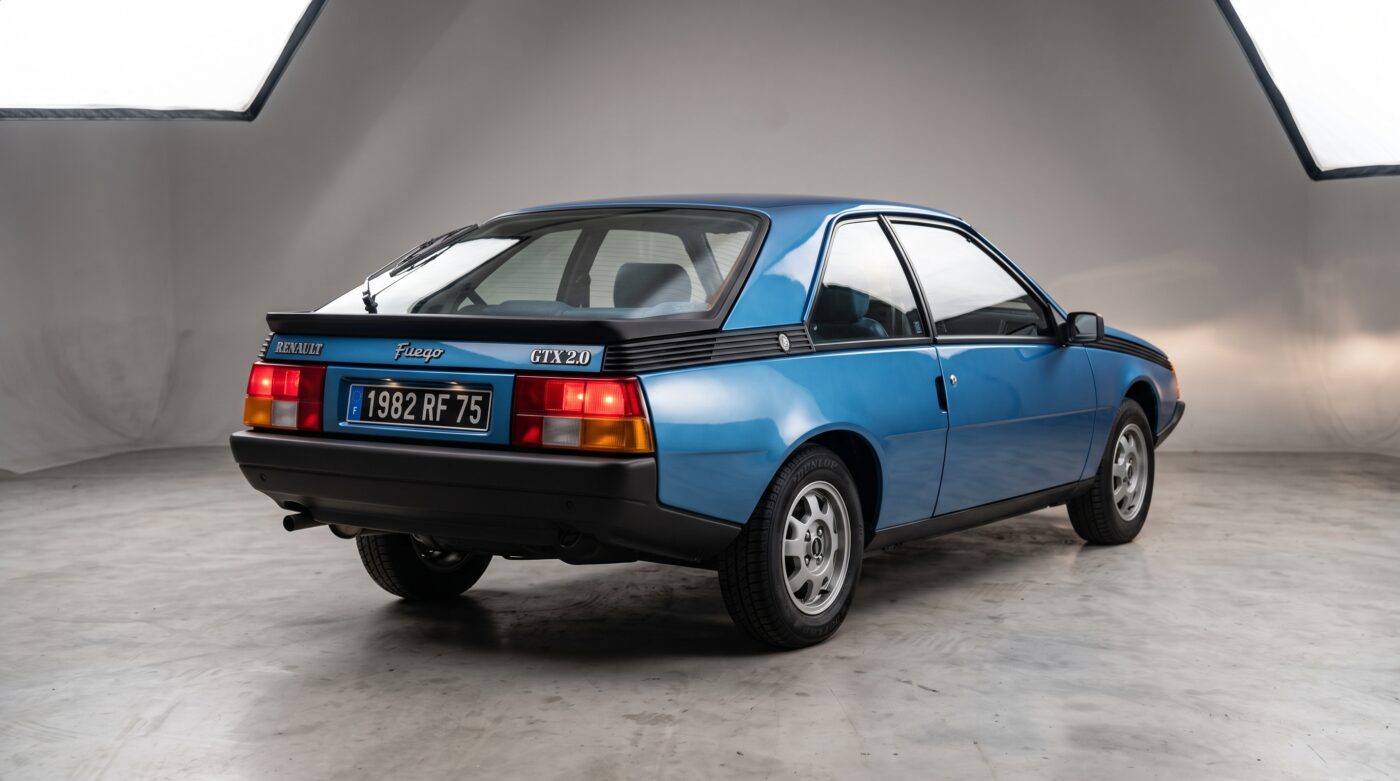 Vue de trois quarts arrière de la Renault Fuego bleu mettant en valeur ses lignes caractéristiques.